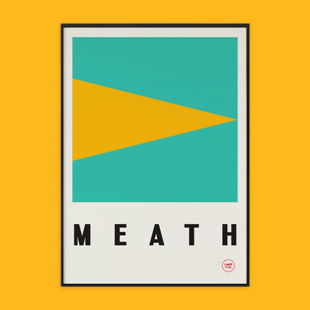 The photo shows a poster on an orange background. The poster is the gold and green colours of county Meath with the word Meath written underneath