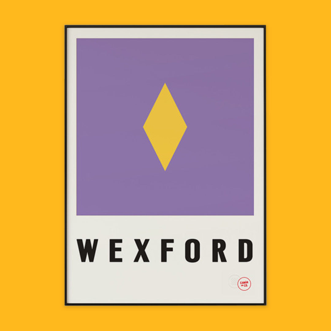 The photo shows a poster on an orange background. The poster shiws the yellow and purple coloours of county Wexford with the word Wexford written underneath.