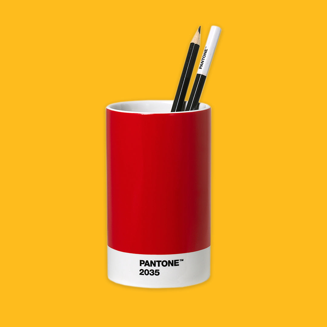 Red PANTONE cup with two pencils on a yellow background