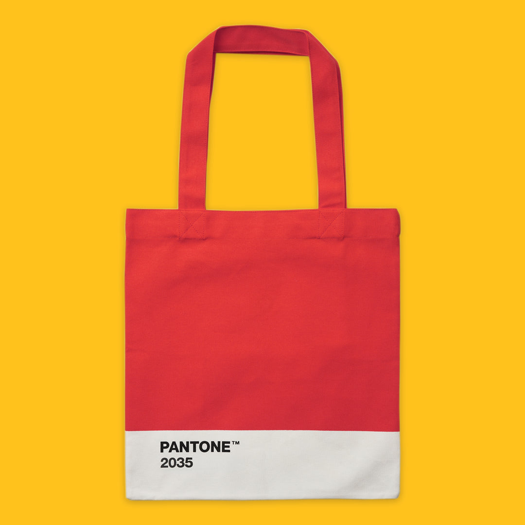 Red tote bag with Pantone 2035 color swatch on a yellow background