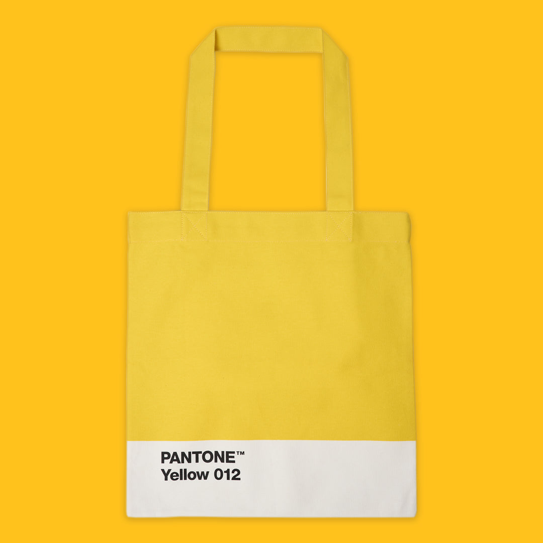 Yellow tote bag with Pantone Yellow 012 label on a yellow background