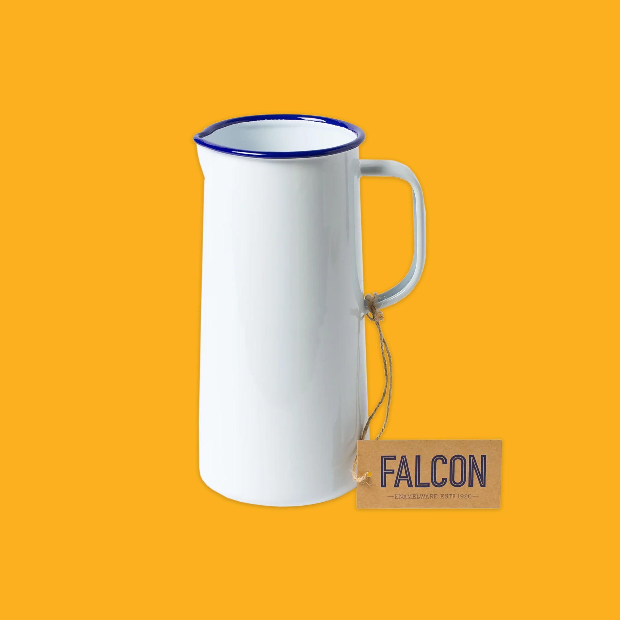 White enamel jug with blue rim on a yellow background, featuring a 'Falcon' tag.