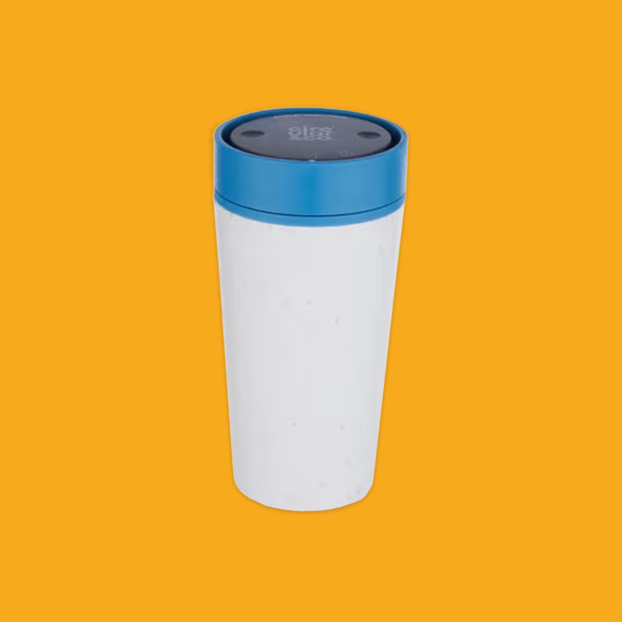White tumbler with a blue lid on an orange background