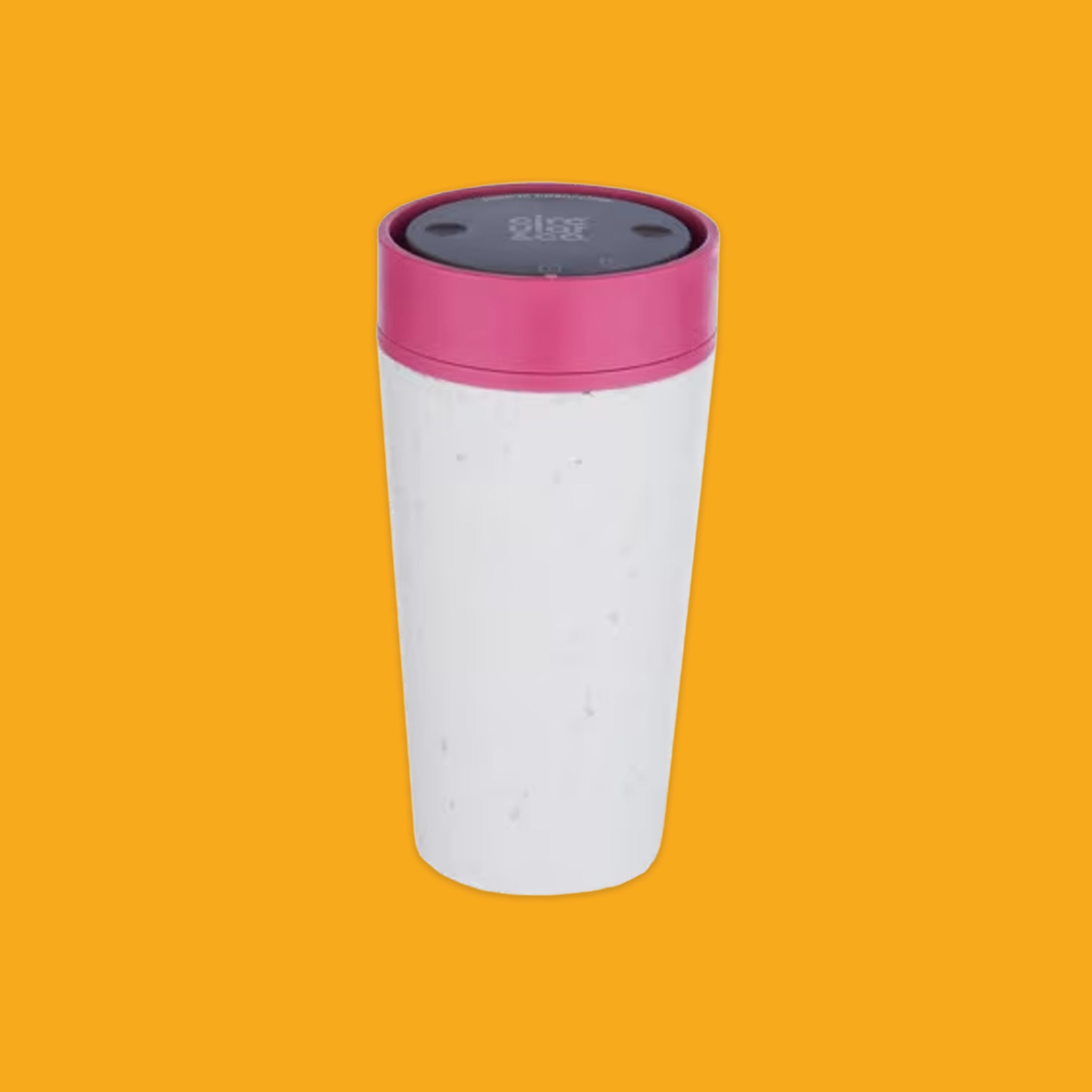 White coffee mug with a pink lid on an orange background