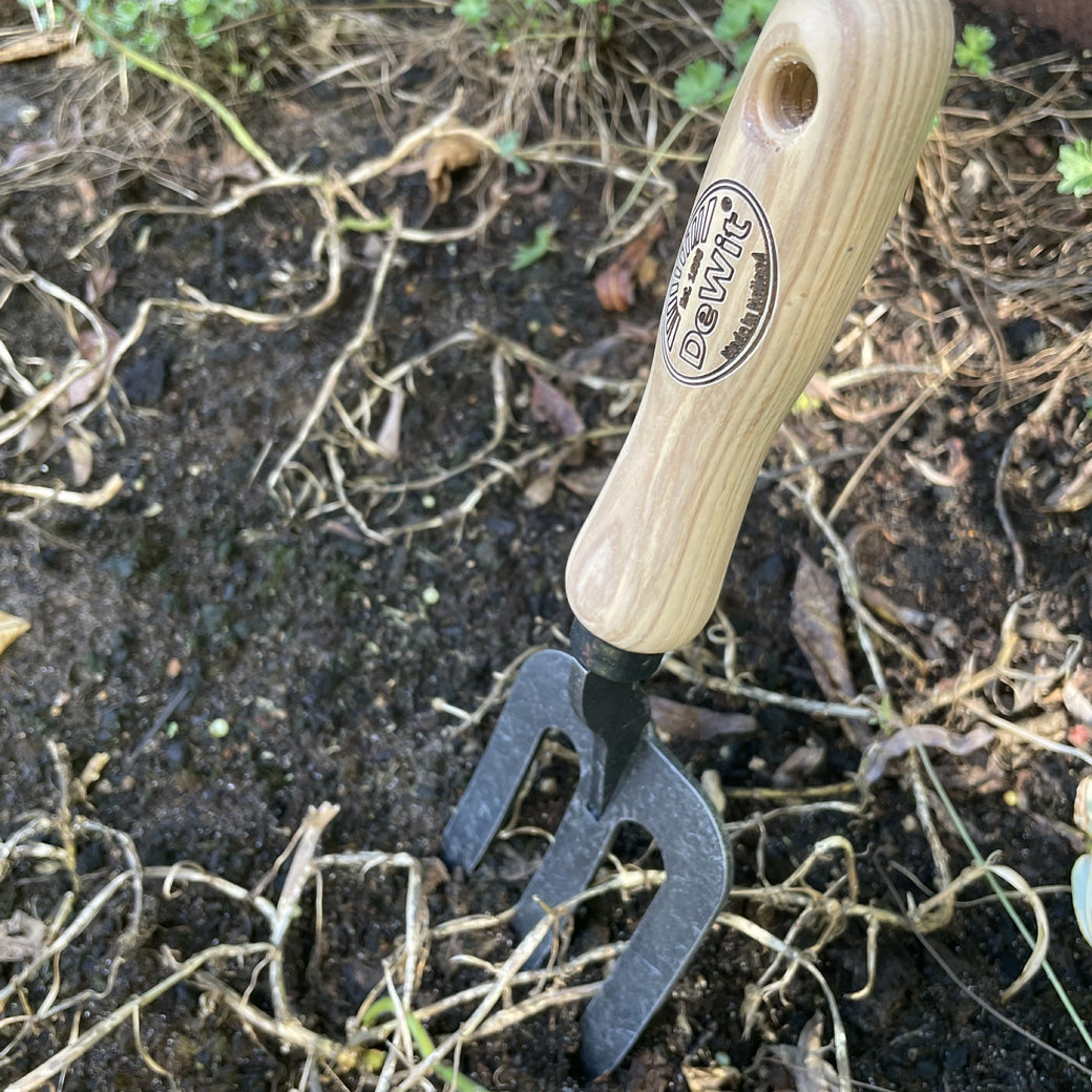 DeWit Handfork Welldone with ash handle stuck in soil