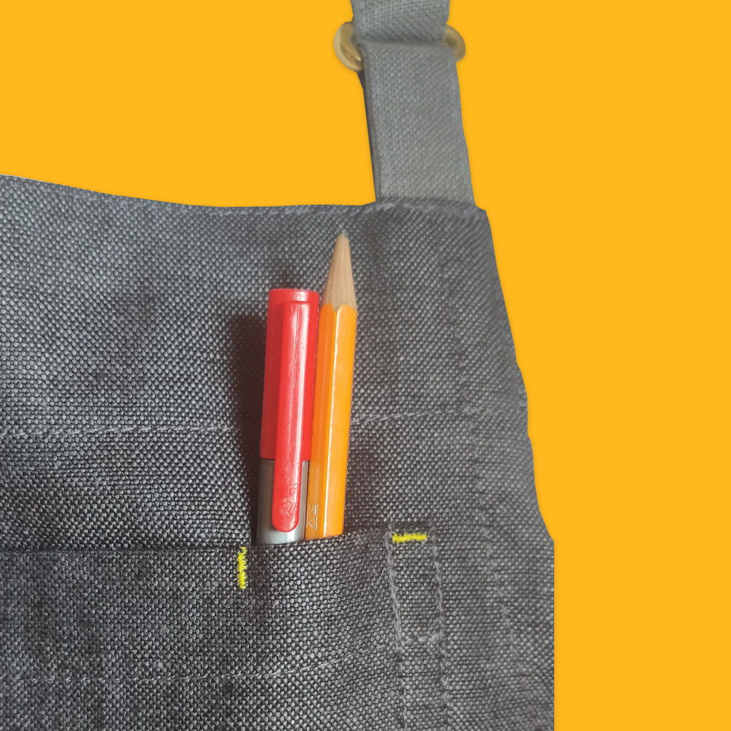 Enrich and Endure hark. Apron in Charcoal. Bartack stitching for reinforcement