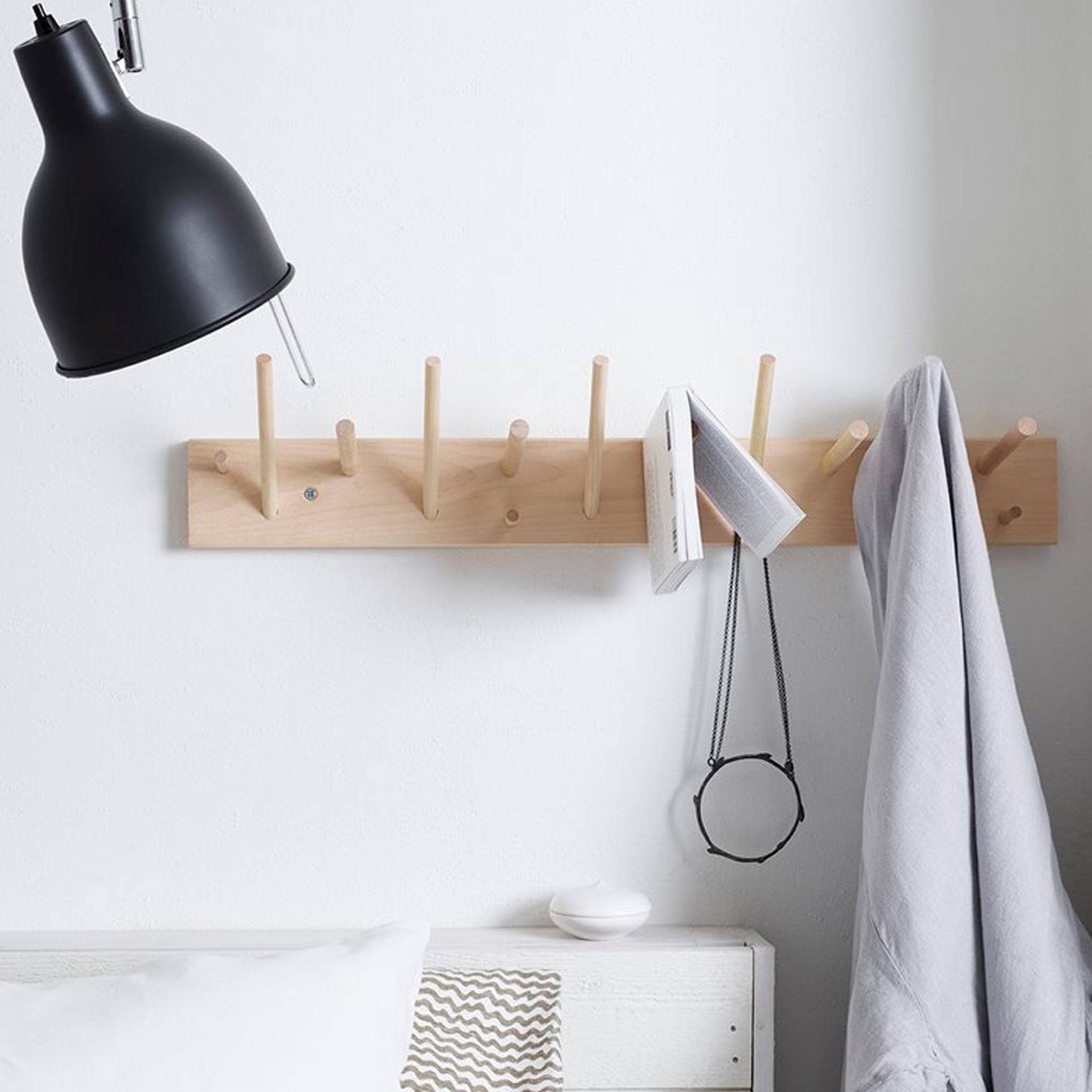 Multihanger with book and towel hanging from it.