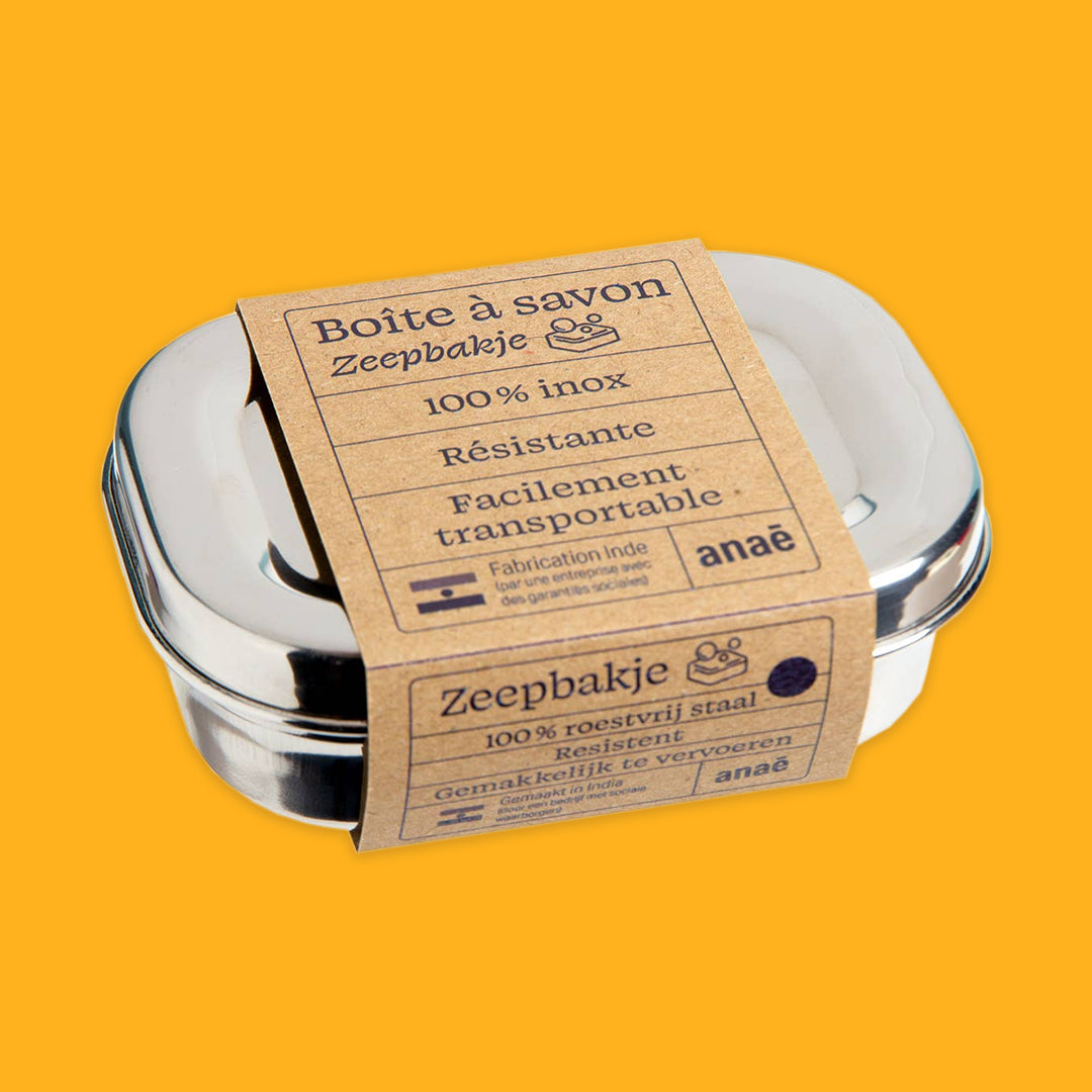 Stainless steel soap container with a cardboard label on an orange background