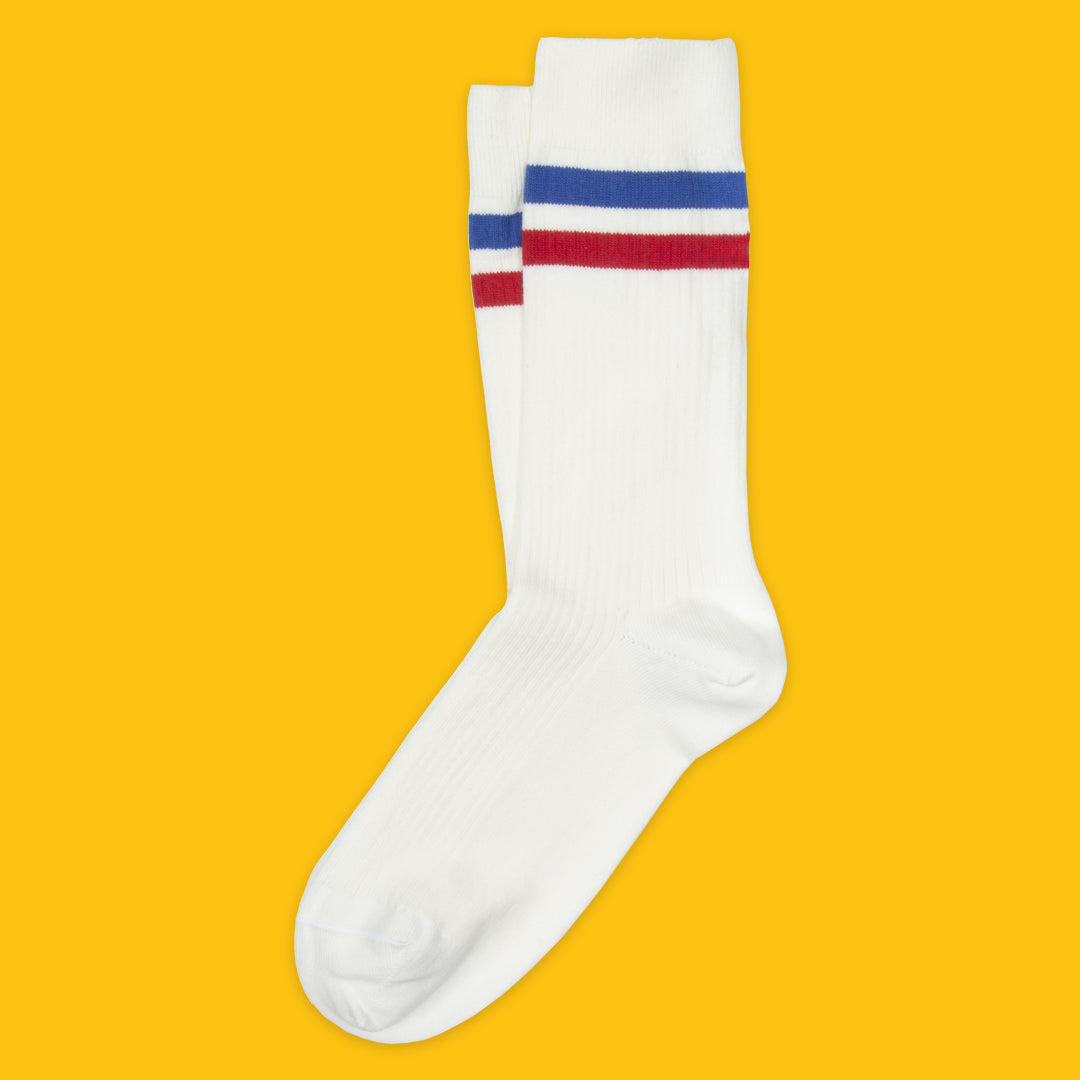 White sock with red and blue stripes on a yellow background