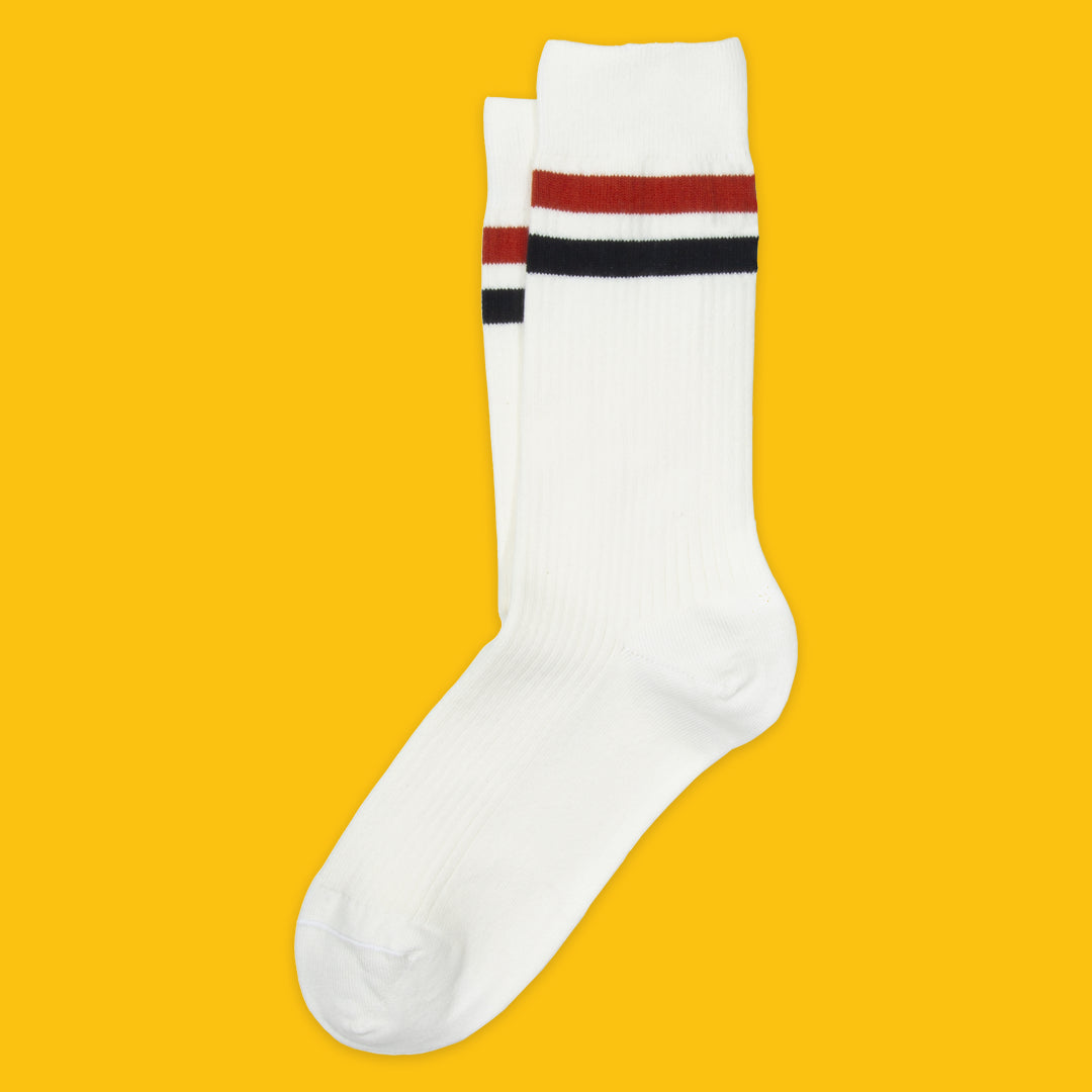 White sock with red and black stripes on a yellow background