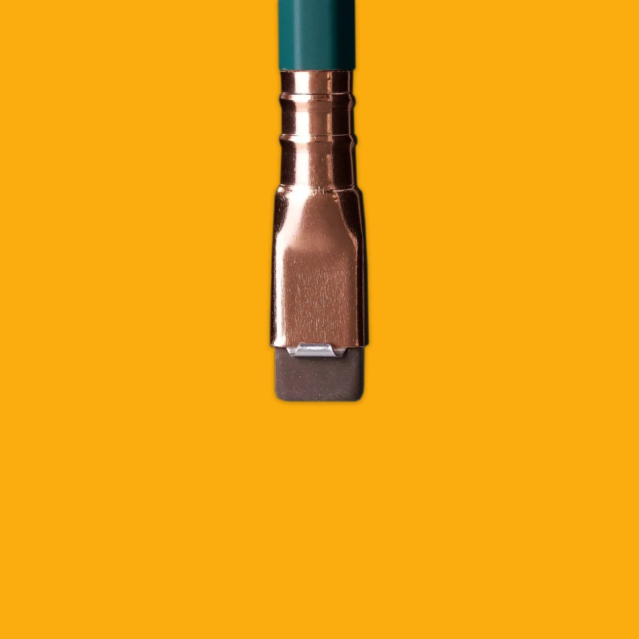 Cooper hold and eraser on the end of a green pencil on a yellow background