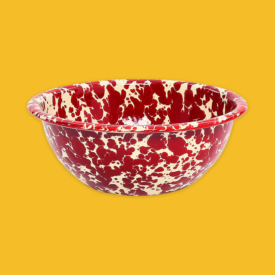 Burgundy and cream splatter bowl on a yellow background