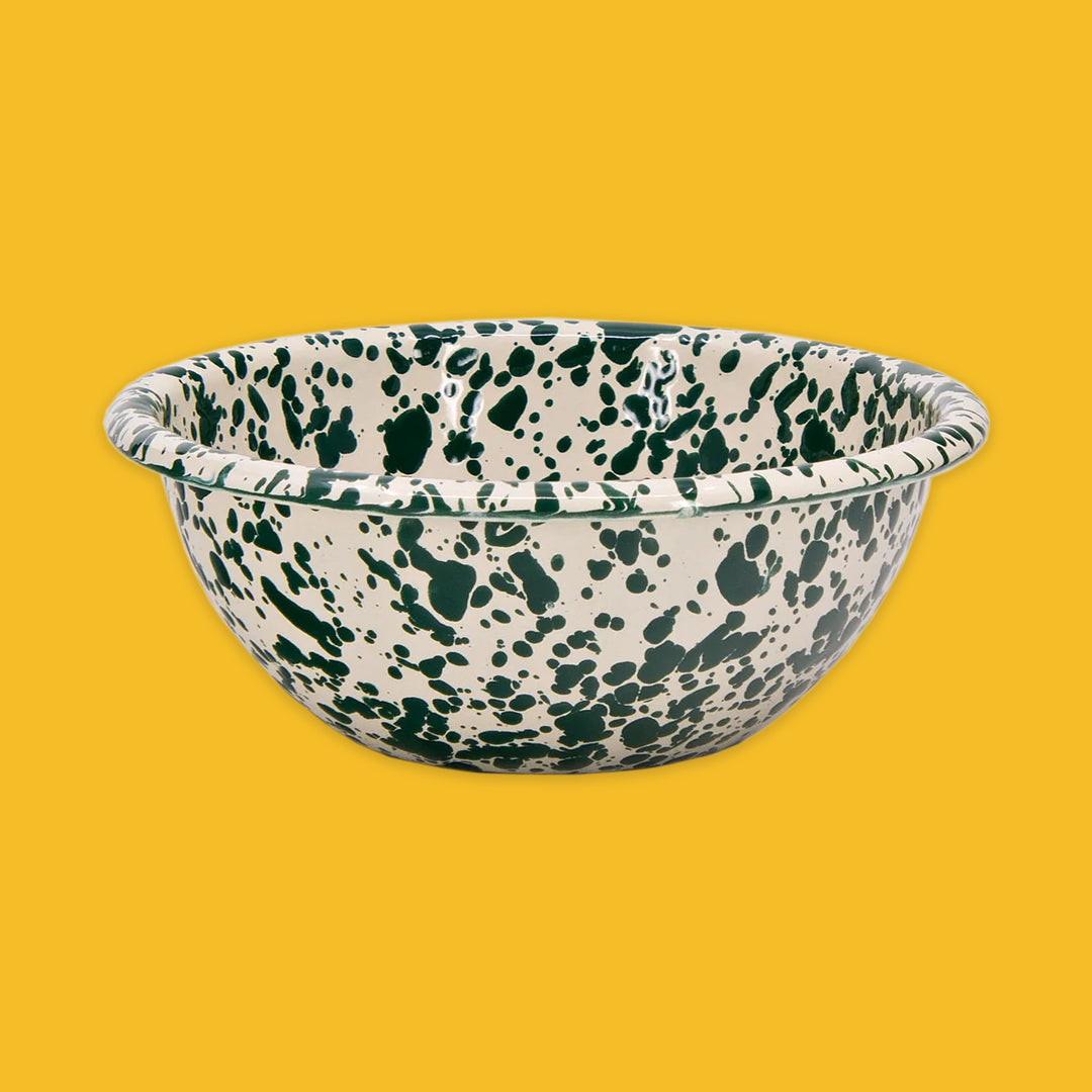 Green and cream splatter bowl on a yellow background