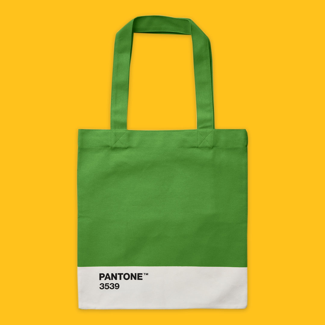 Green tote bag with Pantone colour swatch on a yellow background