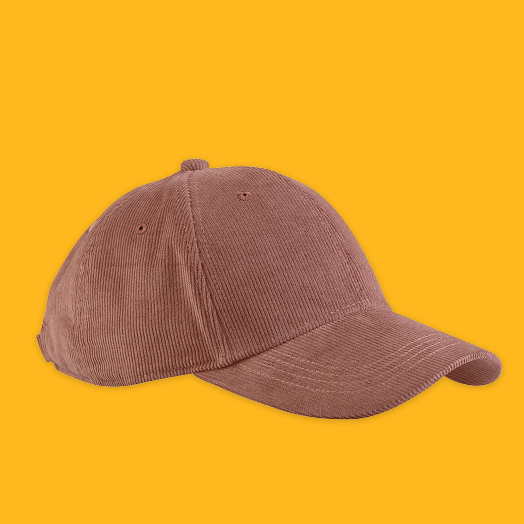 Dusty brick corduroy cap on a yellow background