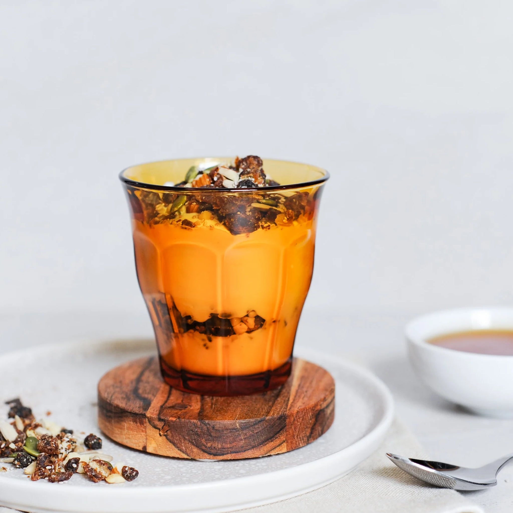 Amber glass with yoghurt dish inside on a table