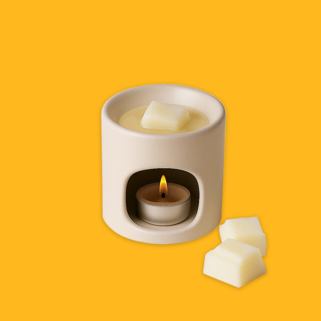 Stoneware wax burner with wax melting over a tealight on a yellow background 