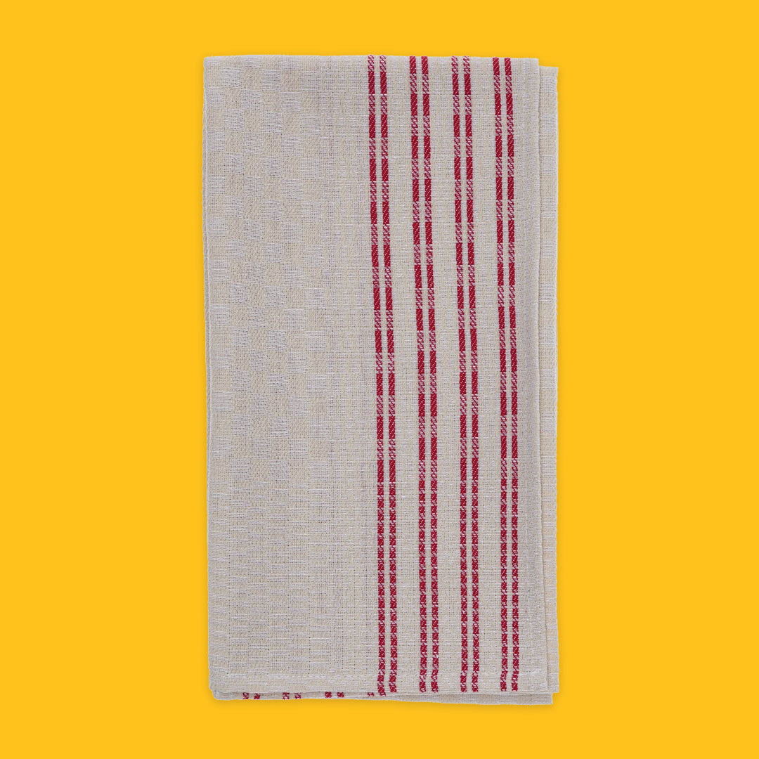 Folded Tea Towel in Beige with Red Stripe on yellow background