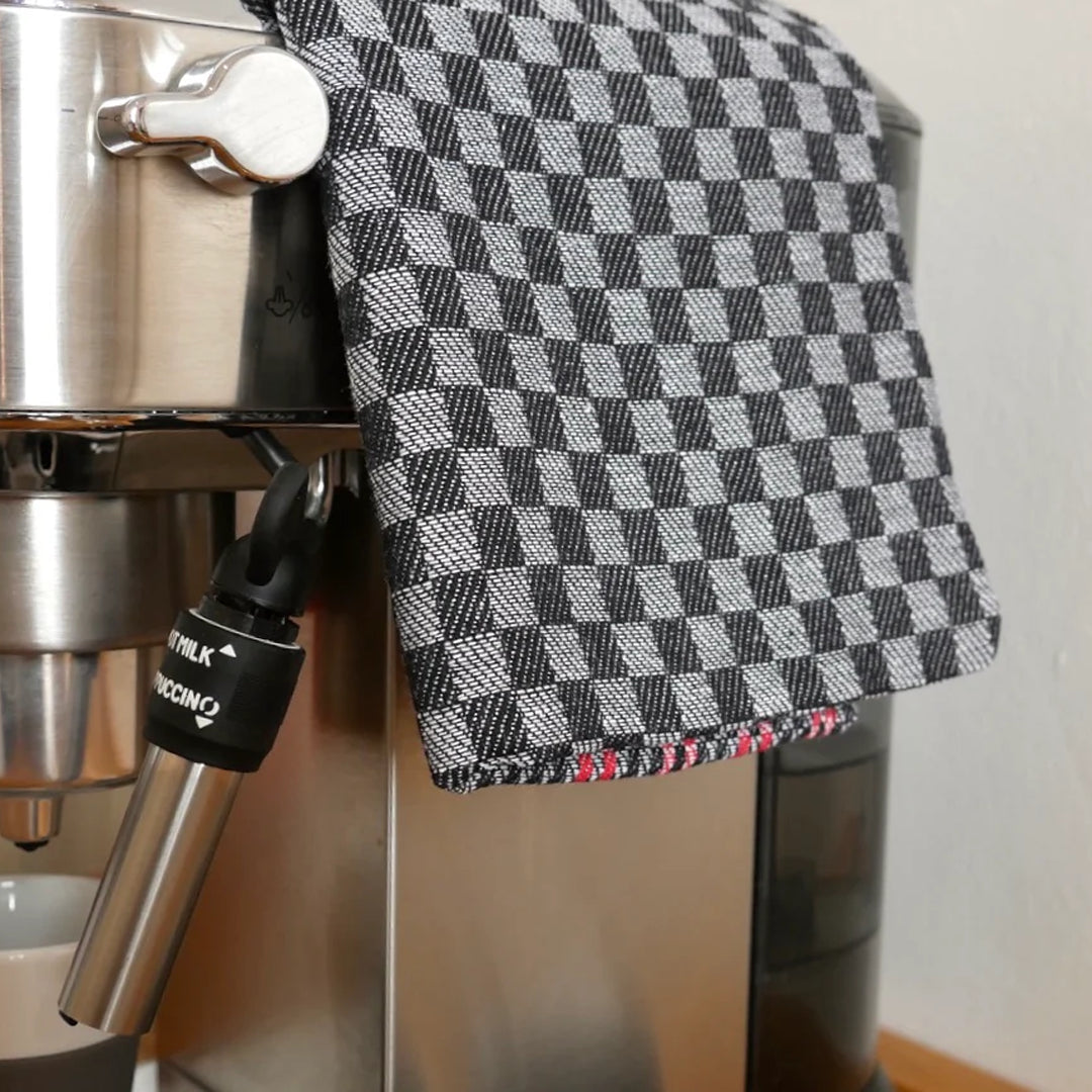 Folded Tea Towel in Black with Red Stripe on coffee machine