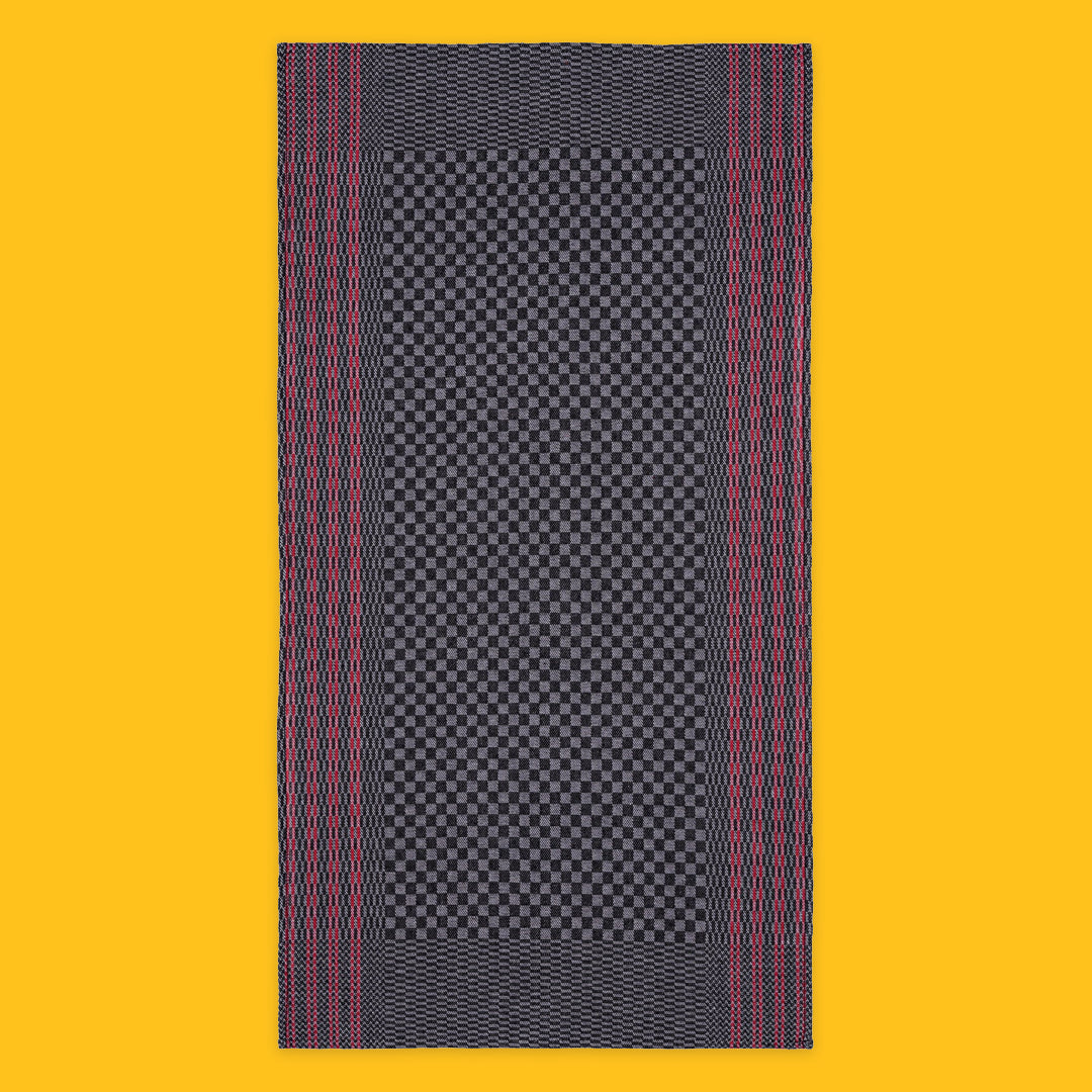 Open Tea Towel in Black with Red Stripe on yellow background