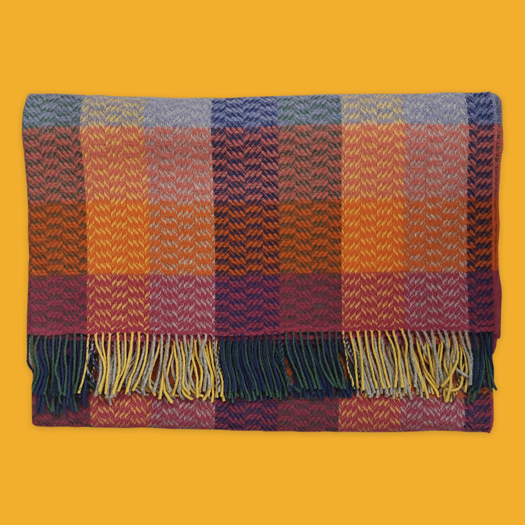 Plaid blanket with multicolour pattern on a yellow background