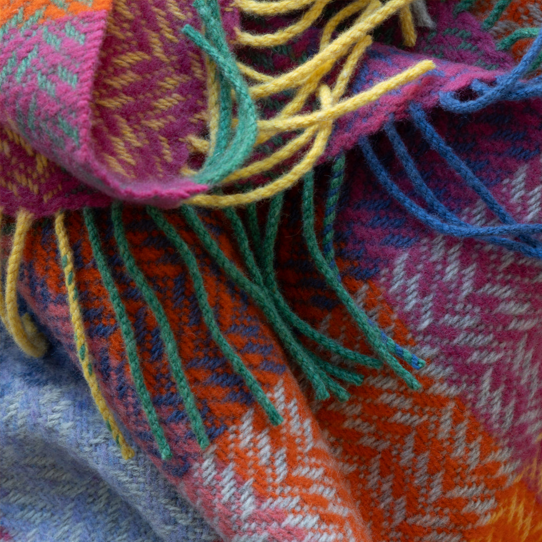 Close-up of a colourful woven fabric with fringes
