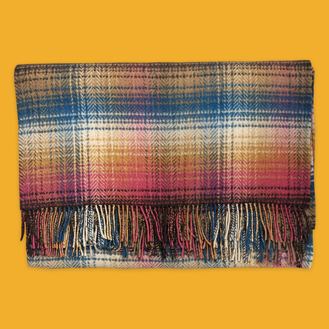 Plaid blanket with colourful pattern on a yellow background