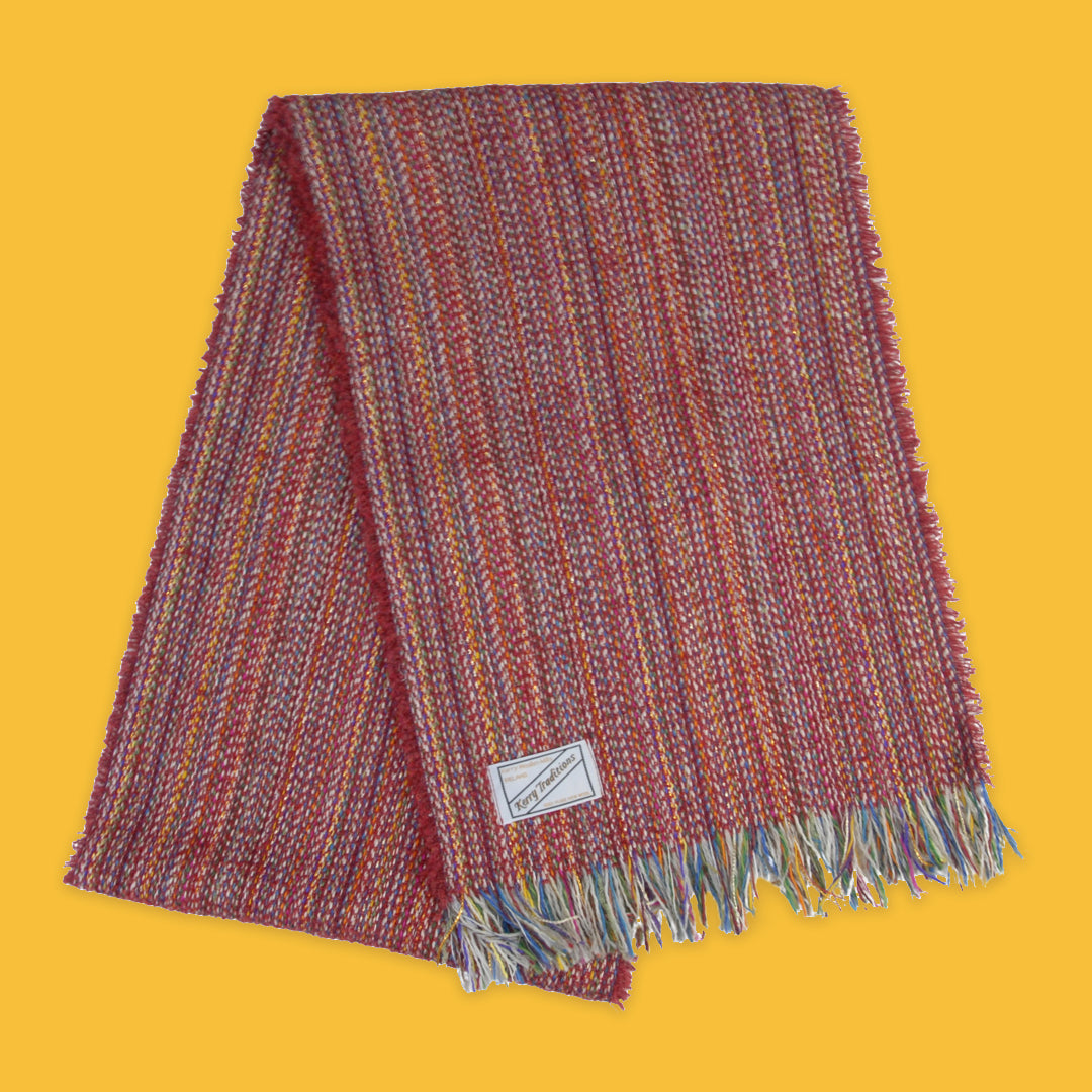 Lambswool Spectrum Scarf in Carmine Red on a yellow background