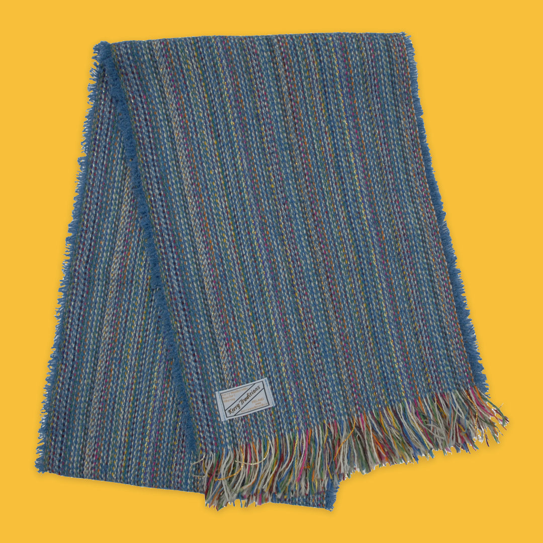 Lambswool Spectrum Scarf in Teal Blue on a yellow background