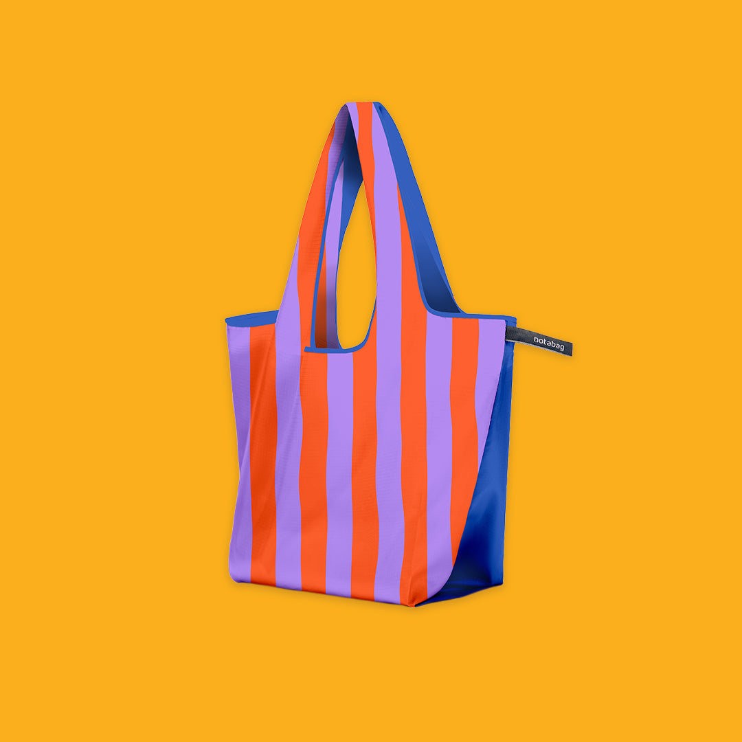 Orange and Purple striped bag with blue accents on an orange background