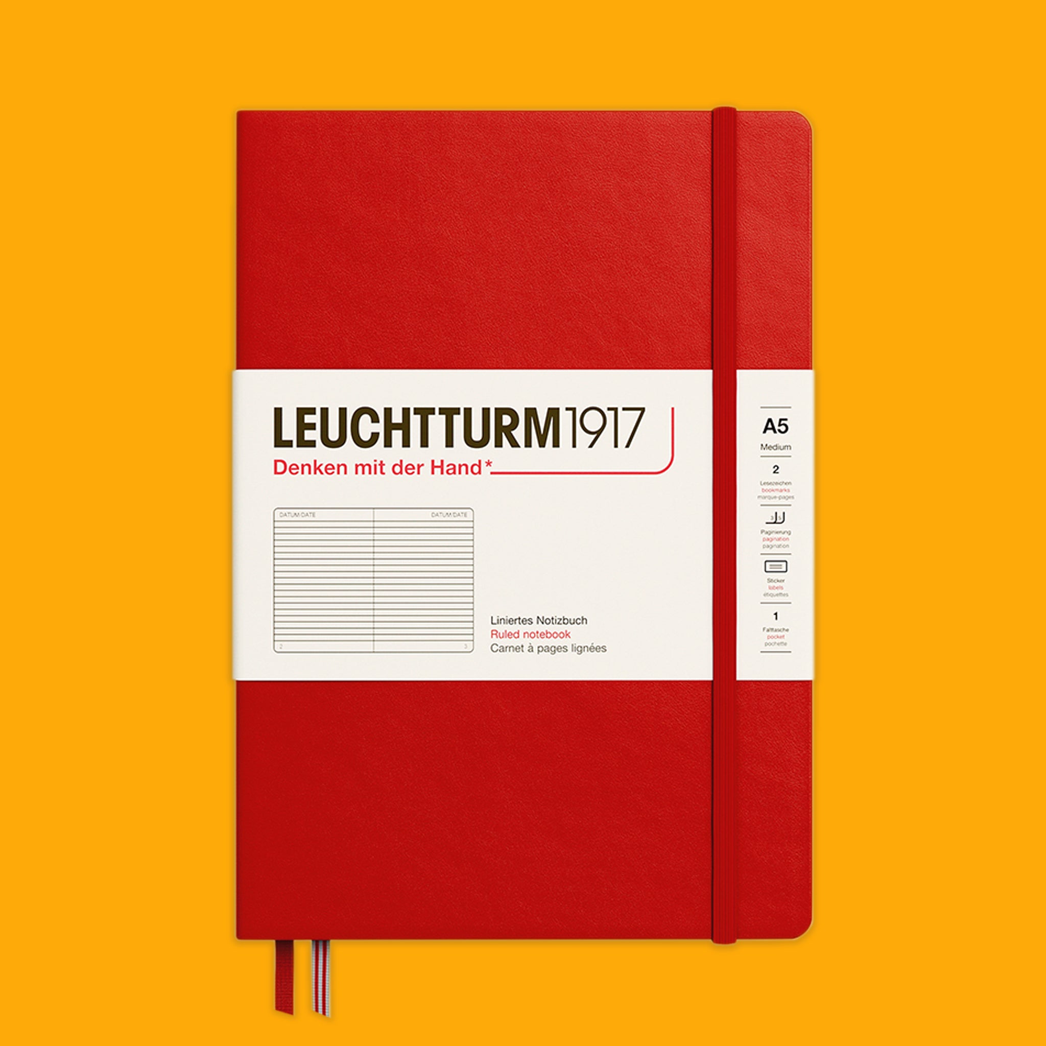 Red notebook with white label on an orange background