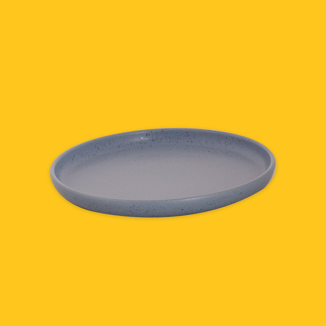 Blue ceramic plate on a yellow background