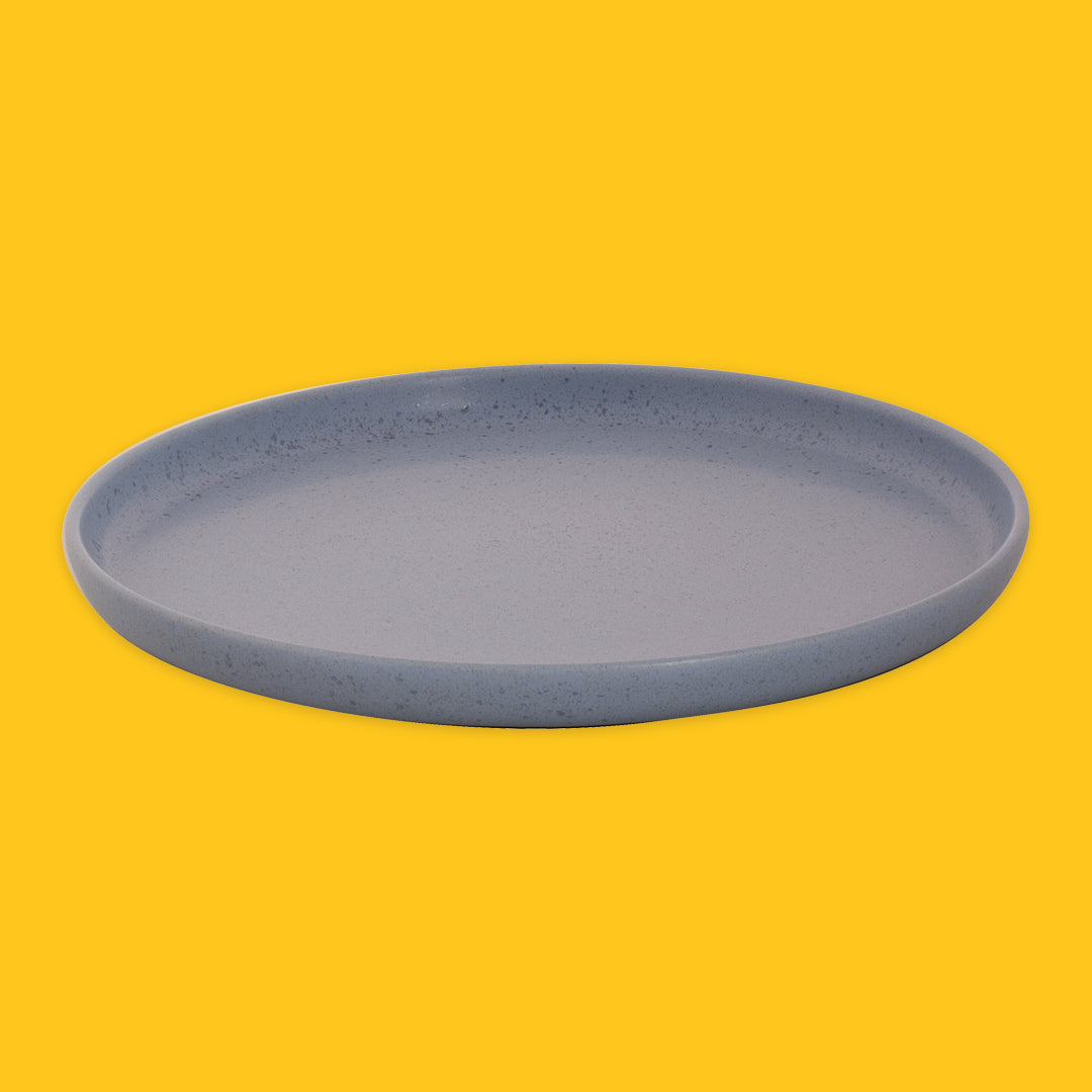 Blue ceramic plate on a yellow background
