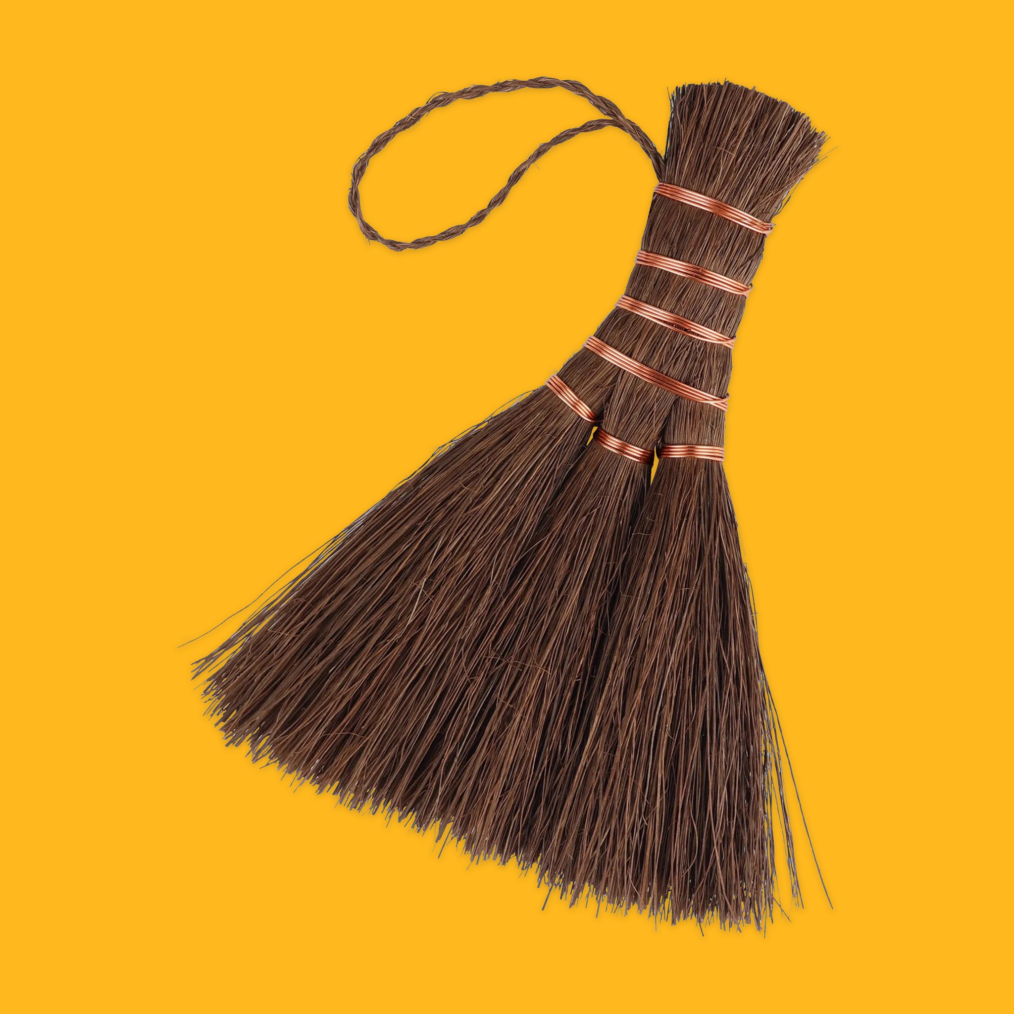 Brown shuro hand broom on a yellow background