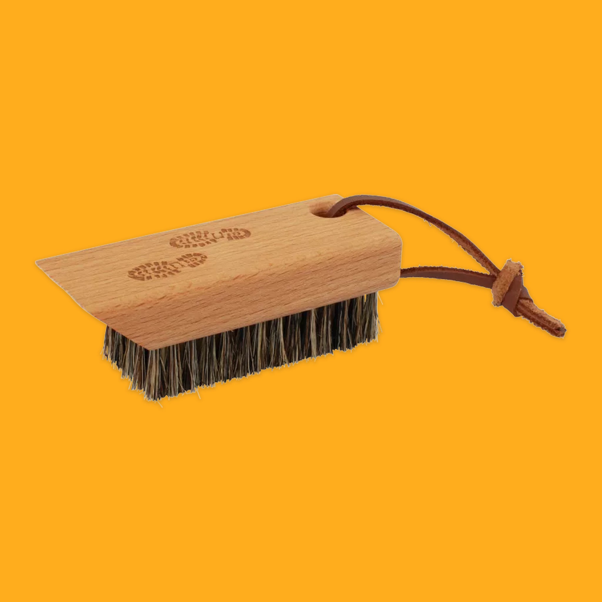 Hiking boot brush on orange background