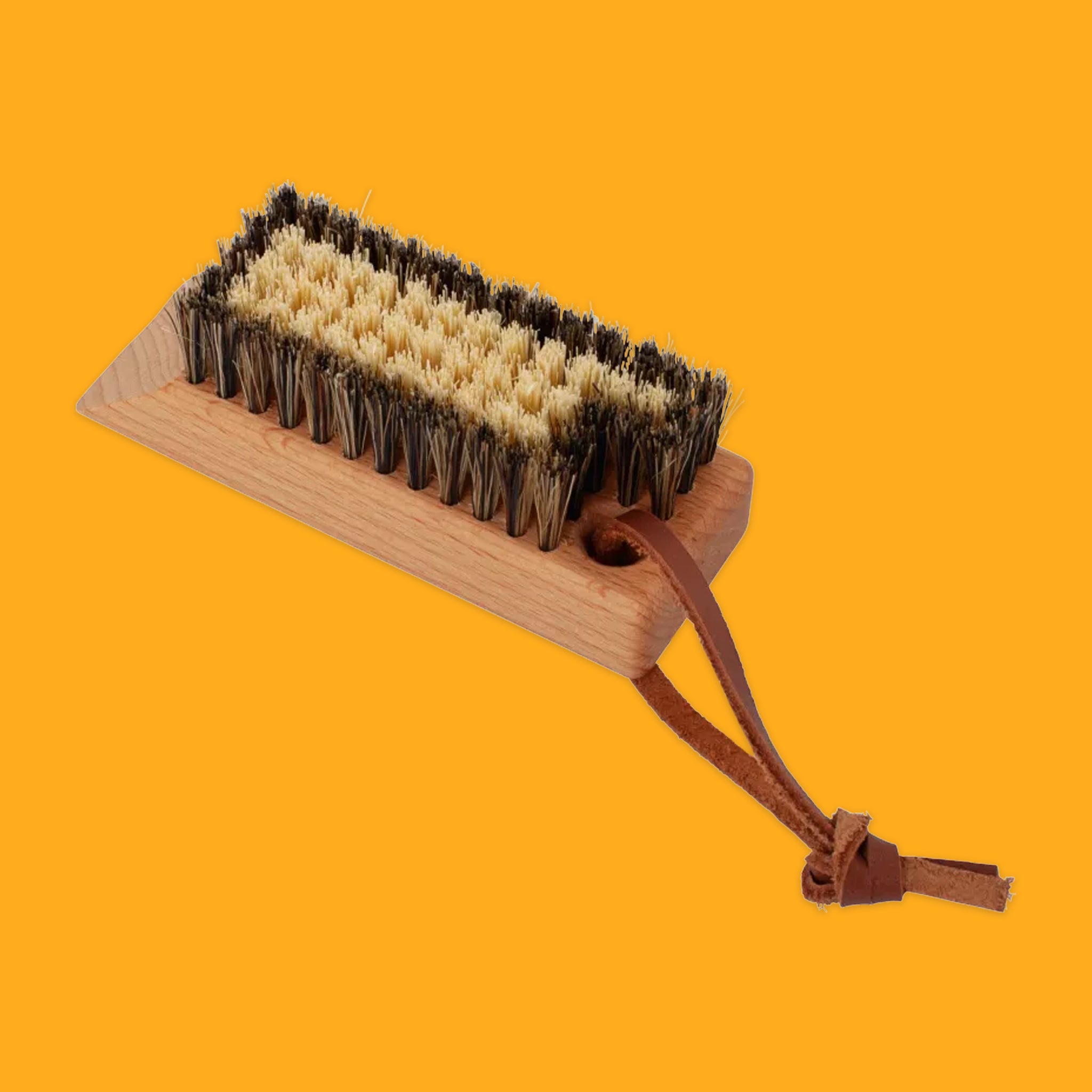 Hiking boot brush on orange background