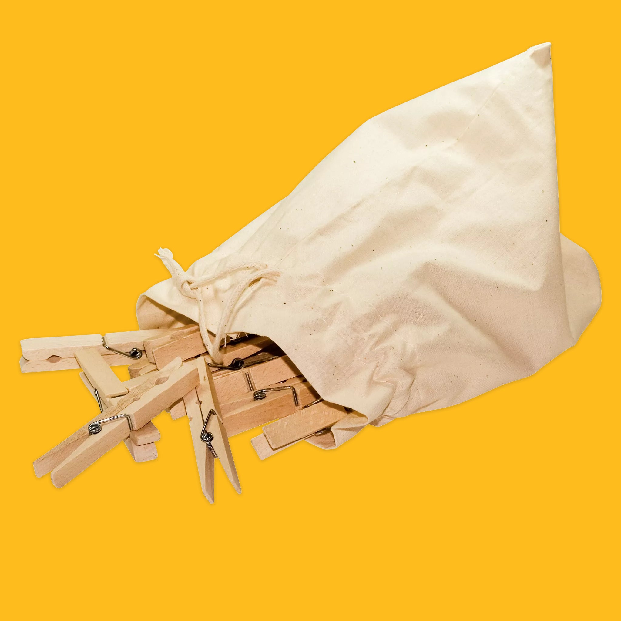 Canvas bag with wooden pegs on a yellow background