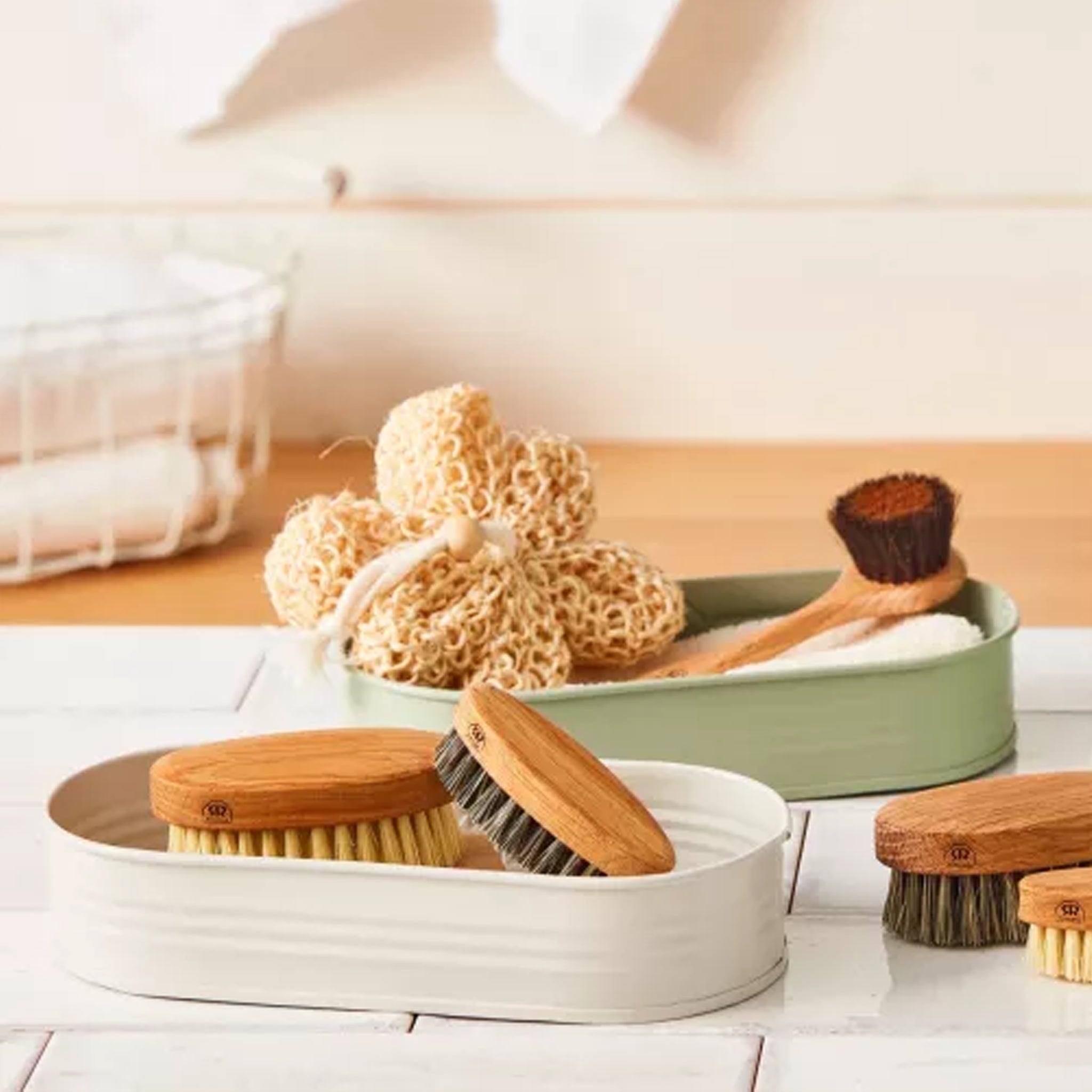 Set of wooden cleaning brushes and sponges stored in storage trays