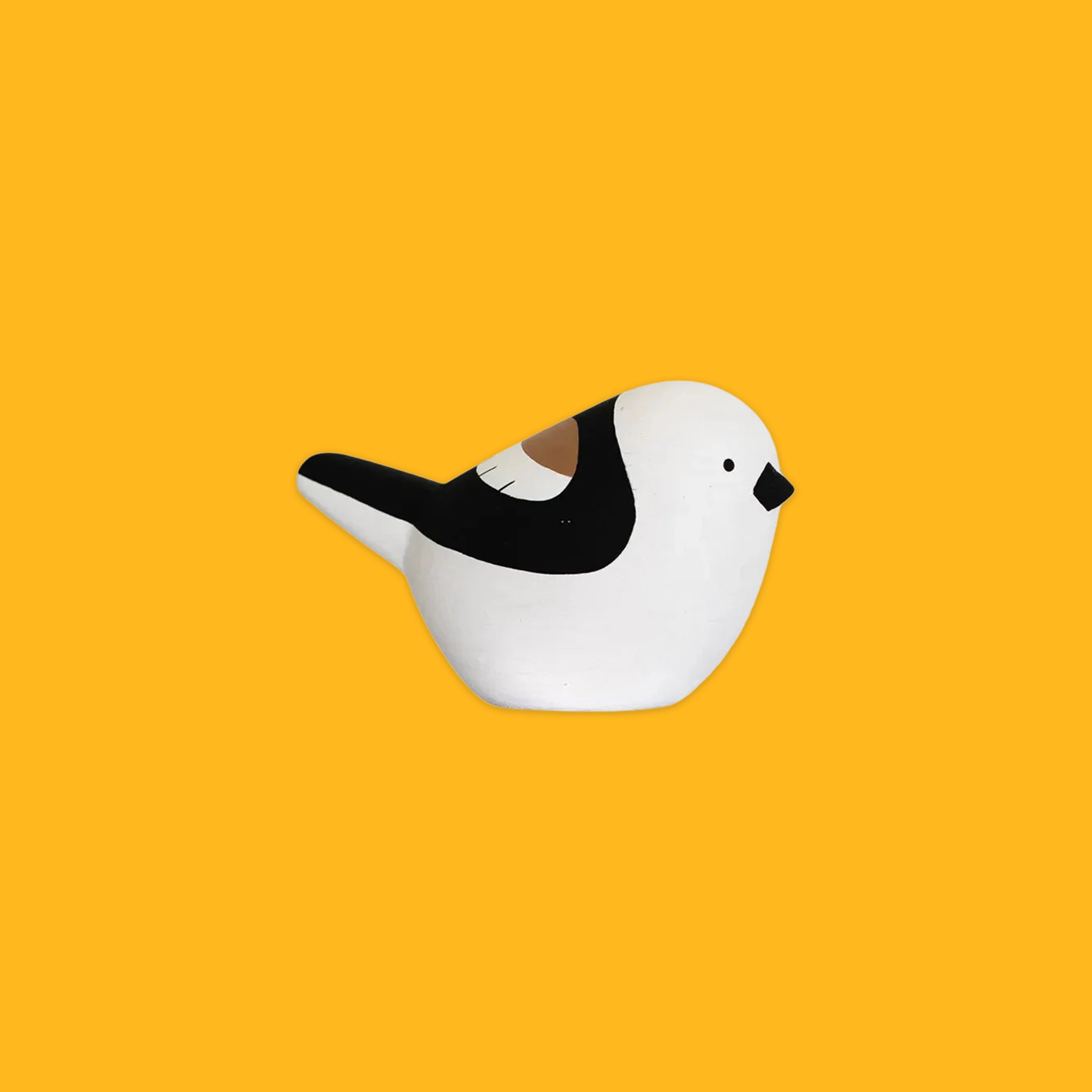 Black and white wooden bird on a yellow background
