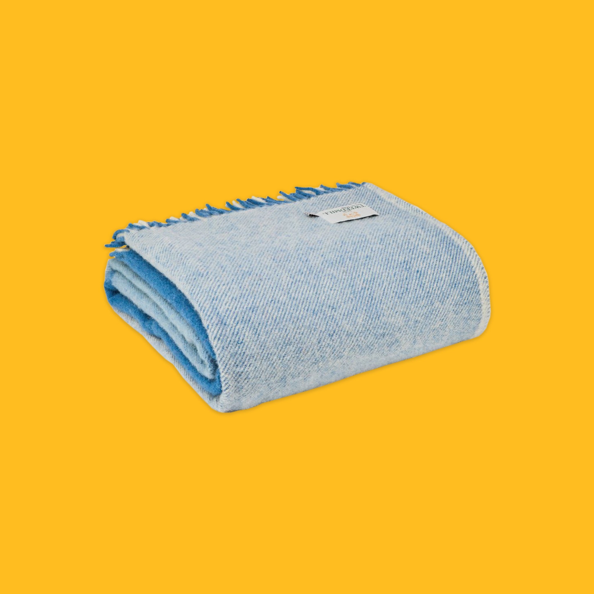 Folded Paddock Check Throw in Blue on a yellow background