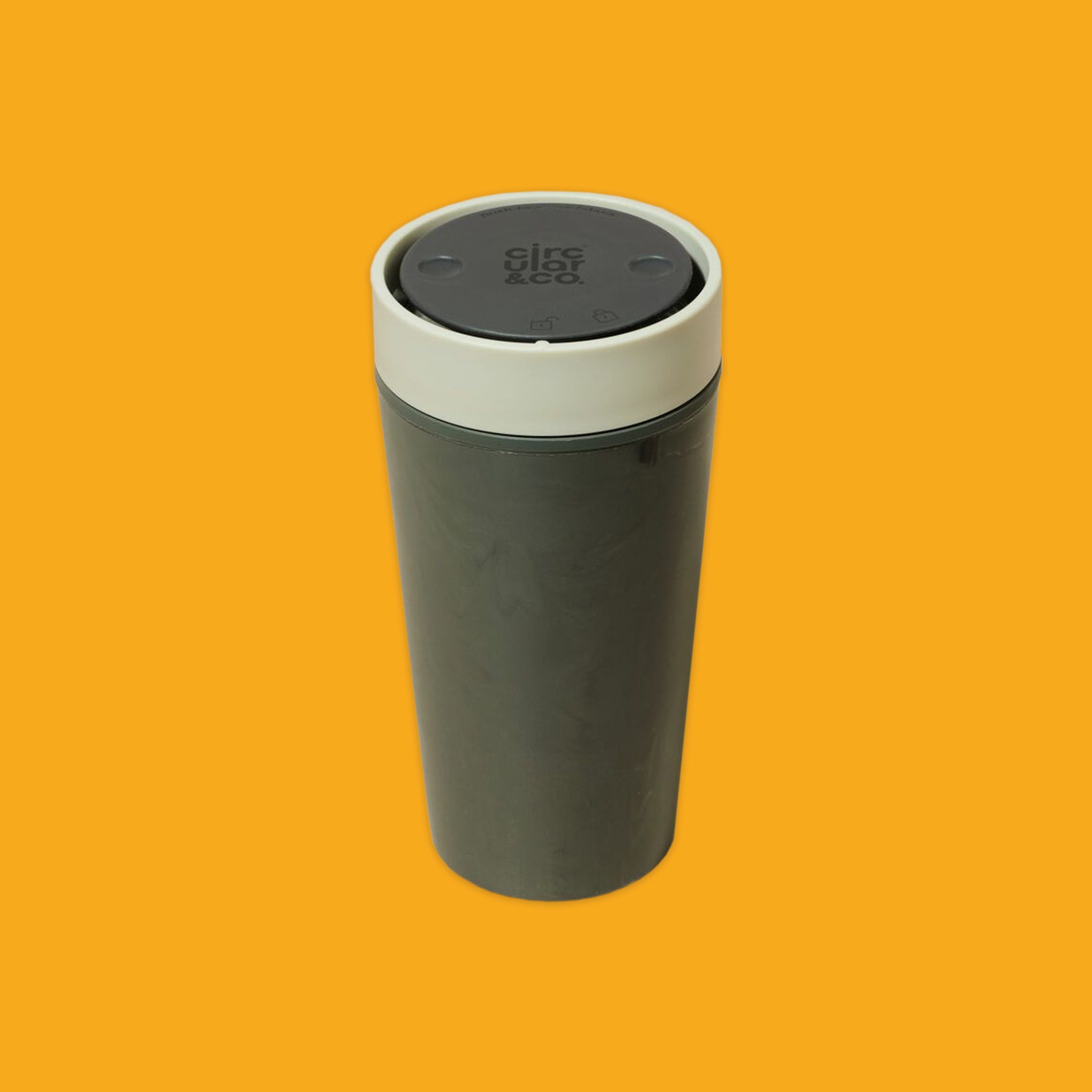 Grey travel mug with a white lid on an orange background