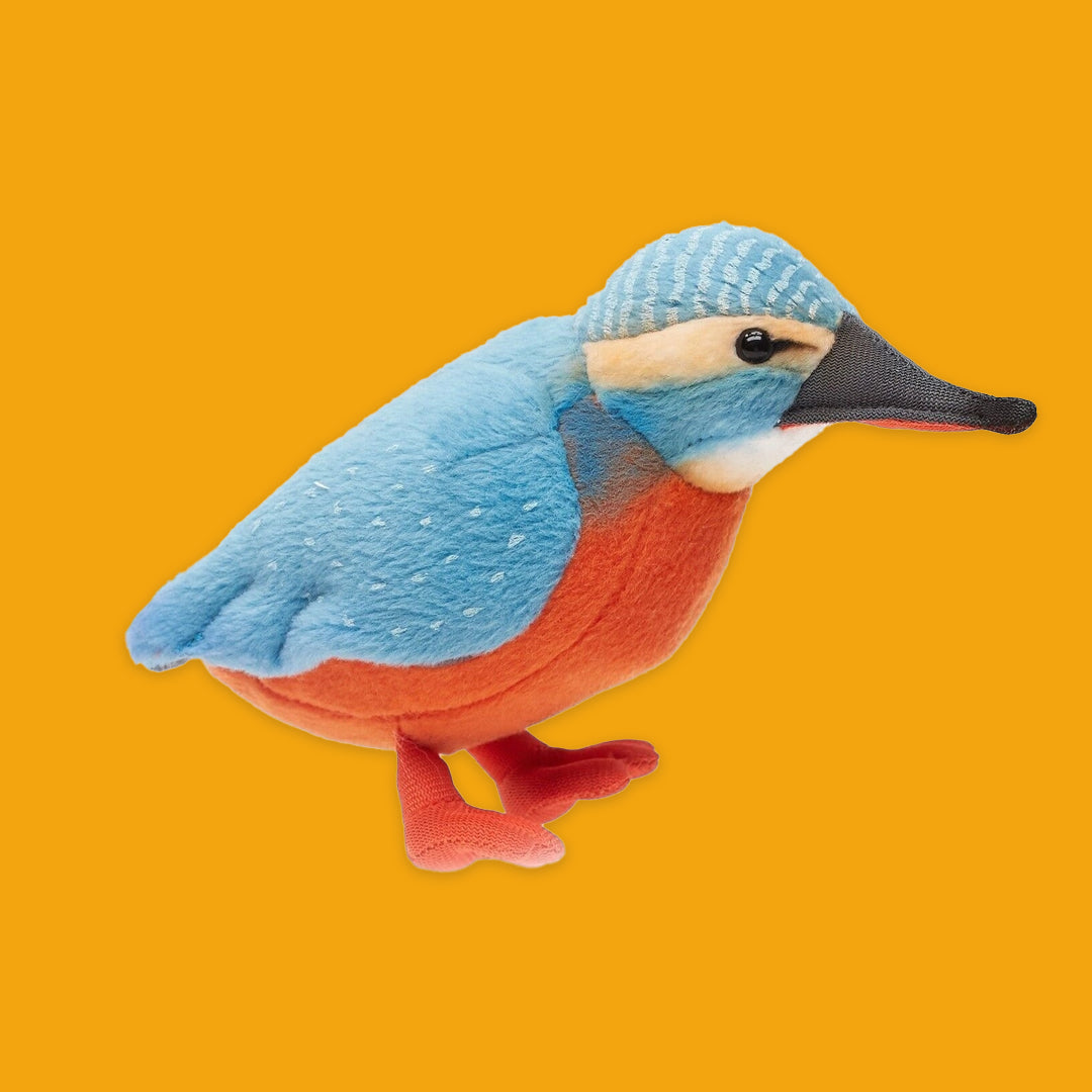 Plush toy kingfisher bird on an orange background