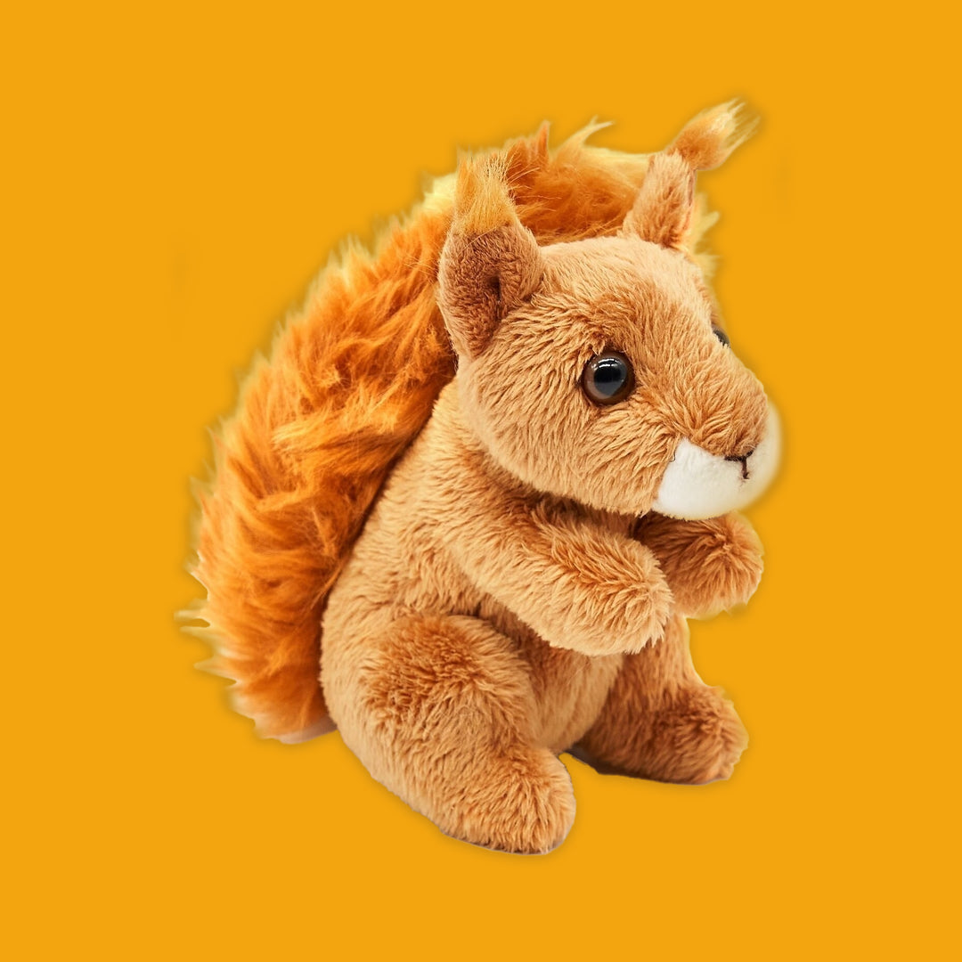 Plush squirrel toy on an orange background