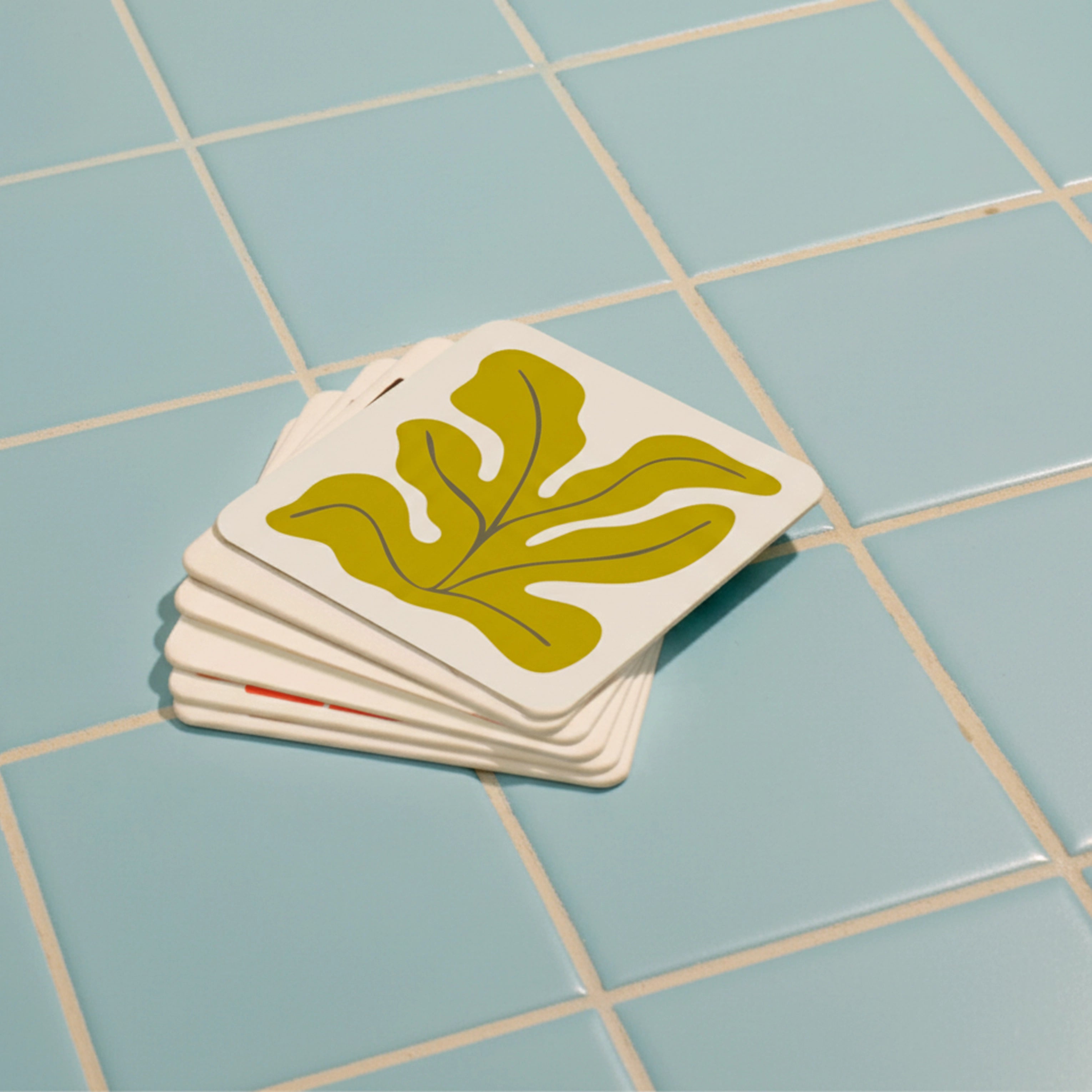 A stack of seaweed coasters on blue tiles