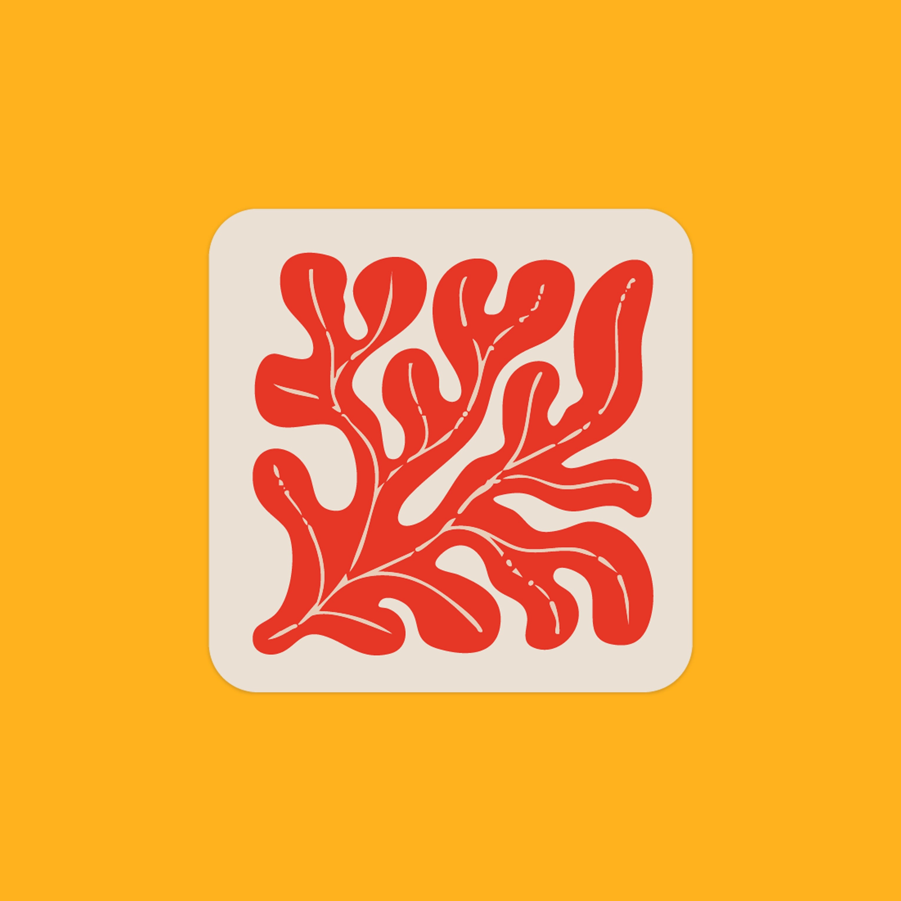 A recycled leather coaster with the image of clay red seaweed on it.