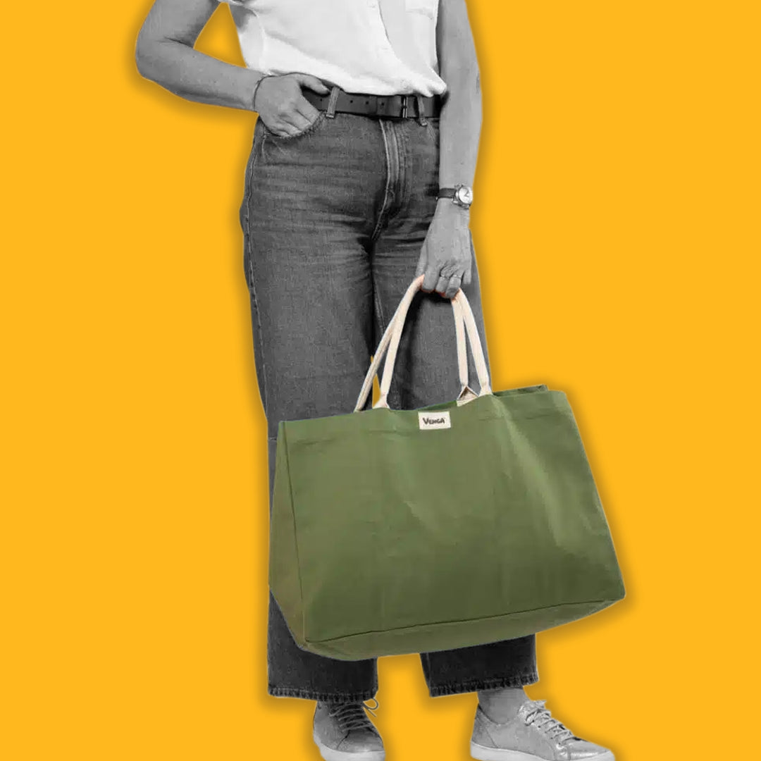 Lady carrying a green tote on a yellow background