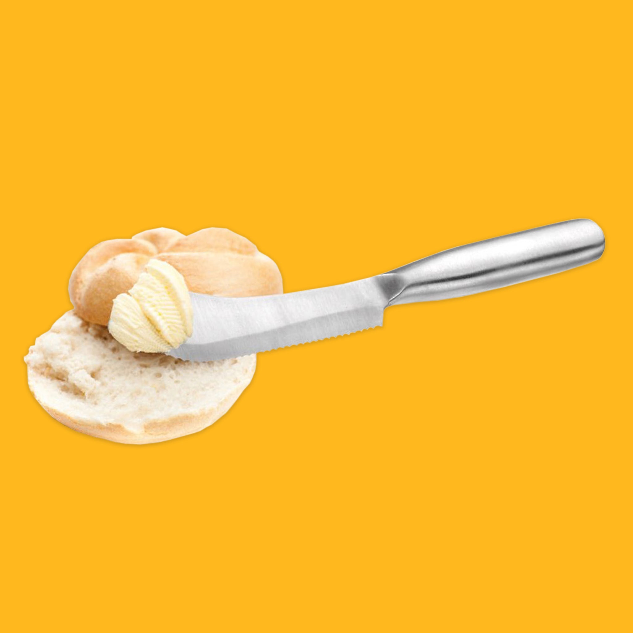 Breakfast knife spreading butter on a roll with a yellow background