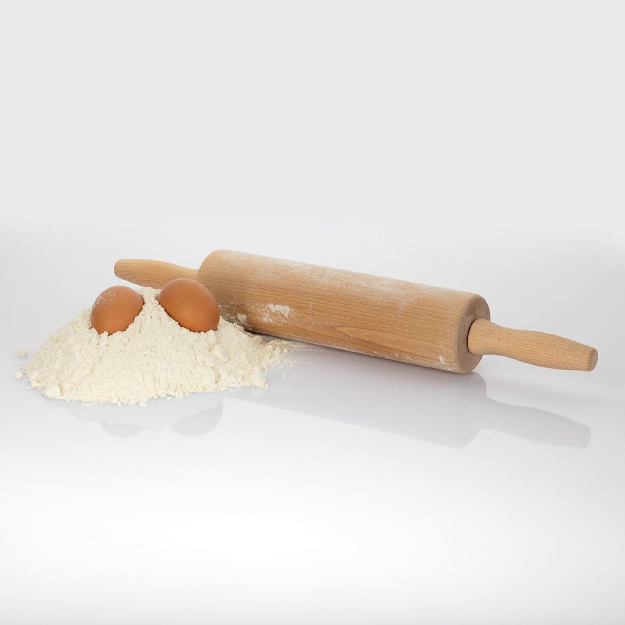 Wooden rolling pin with flour and eggs