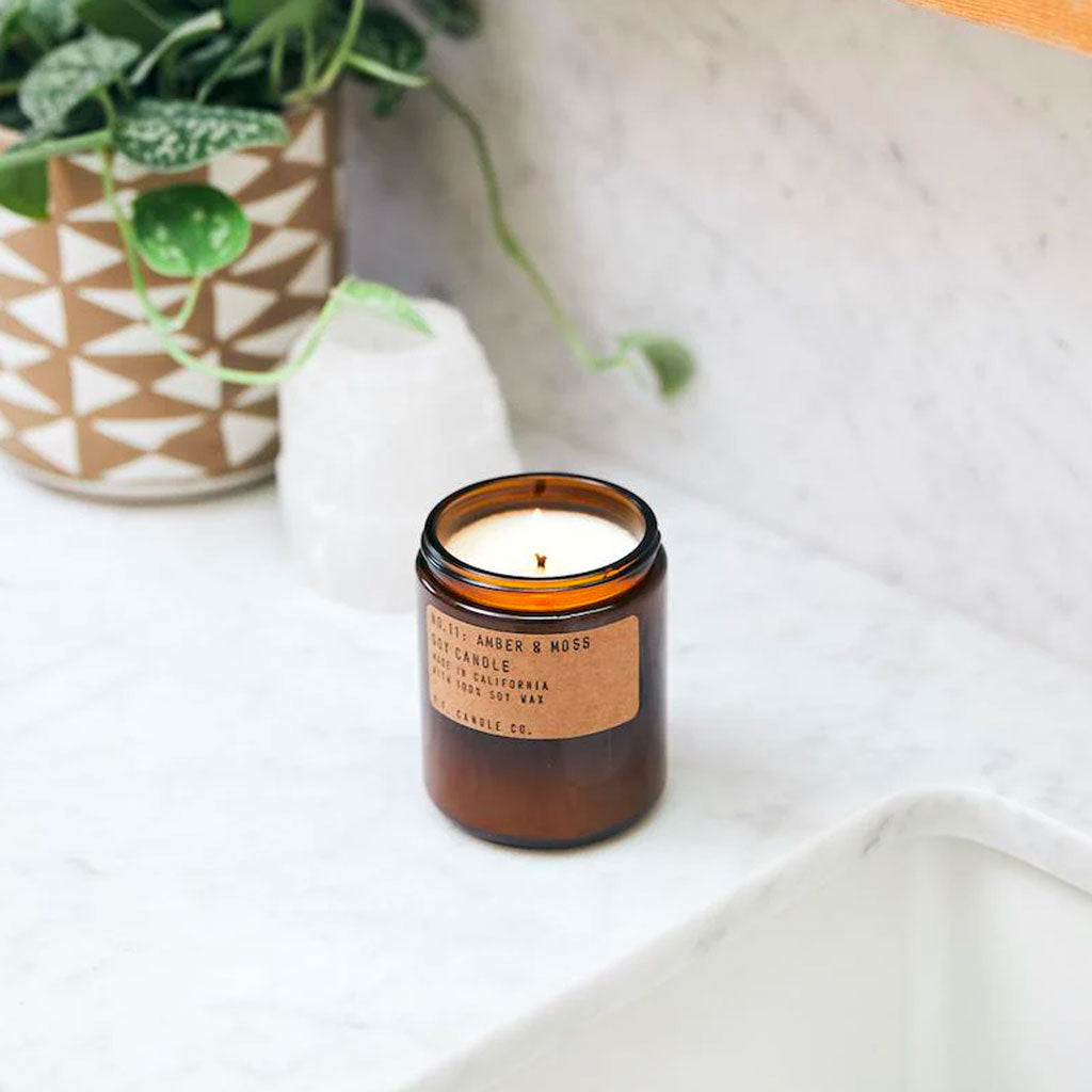 P.F. Candle Co. 7-Oz Amber & Moss on counter