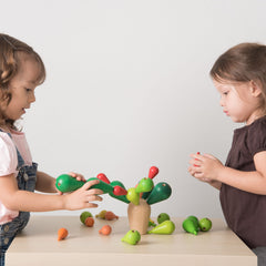 Kids playing with the Balancing Cactus by Plan Toys